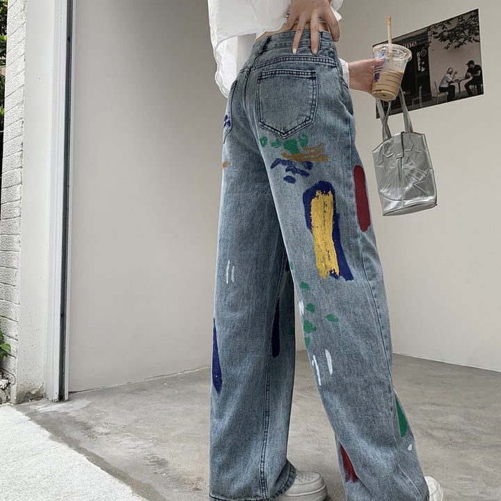 Graffiti spray paint ripped jeans