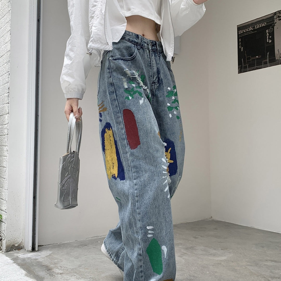 Graffiti spray paint ripped jeans