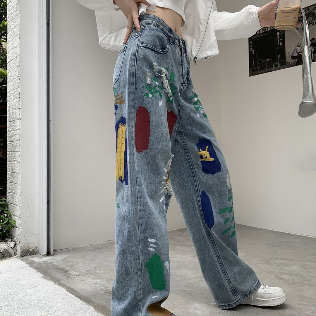 Graffiti spray paint ripped jeans