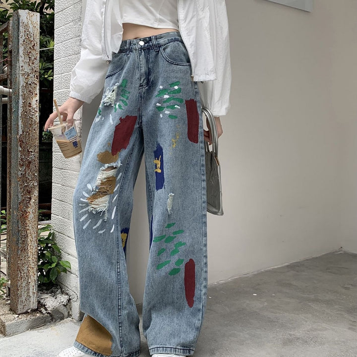 Graffiti spray paint ripped jeans